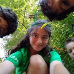 Summer camp chilrdren look into the camera with their counsellor.